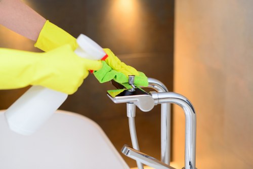 After builders cleaning removing dust from kitchen surfaces